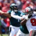 Sep 29, 2024; Tampa, Florida, USA; Philadelphia Eagles quarterback Jalen Hurts (1) is pressured by Tampa Bay Buccaneers linebacker Joe Tryon-Shoyinka (9) in the second quarter at Raymond James Stadium.
