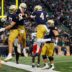 Notre Dame tight end Cooper Flanagan (87) celebrates with quarterback Kenny Minchey (8) after a Flanagan touchdown during a NCAA college football game against Virginia at Notre Dame Stadium on Saturday, Nov. 16, 2024, in South Bend.