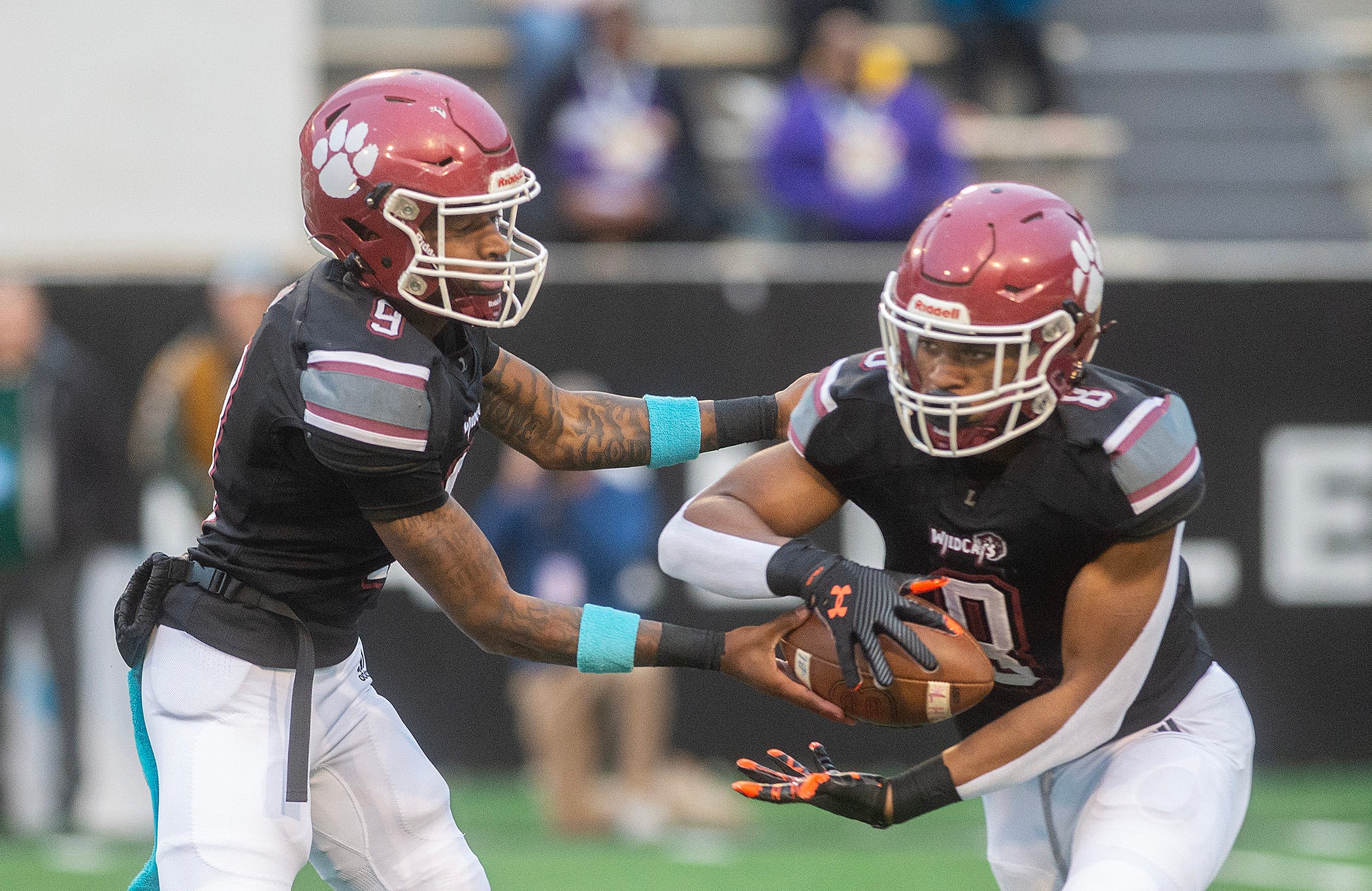 Louisville's quarterback Zavier Hunt (9) hands off to Zaiden Jernigan (8) during play against Louisville in the MHSAA 4A championship game in Hattiesburg, Miss., Saturday, Dec. 7, 2024.