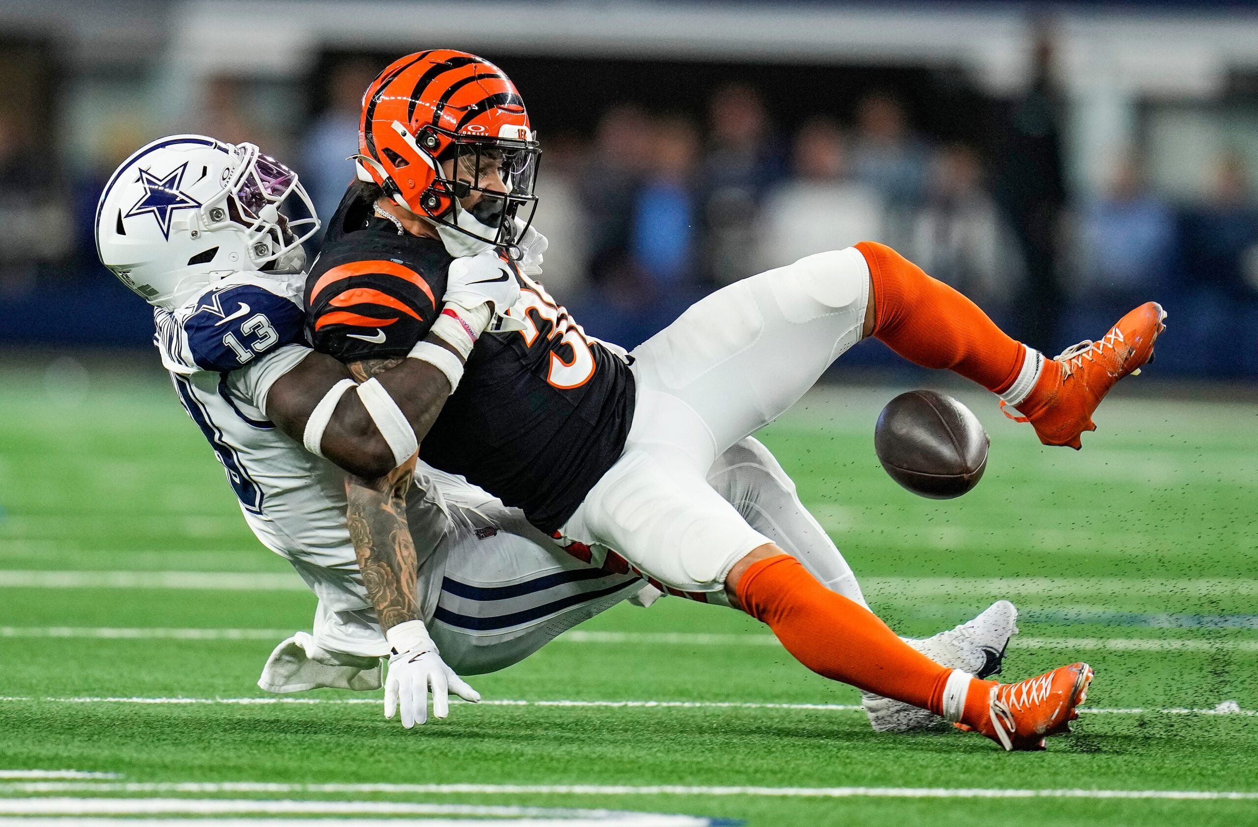 Dallas Cowboys linebacker DeMarvion Overshown takes down Cincinnati Bengals running back Chase Brown (30) Monday Night Football at AT&T Stadium in Arlington, Texas on Monday, December 9, 2024.