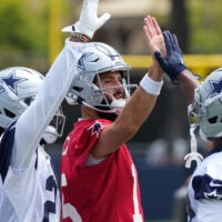 Jul 22, 2025; Oxnard, CA, USA; Dallas Cowboys quarterback Will Grier (15) with running back Javonte Williams (33) during training camp at the River Ridge Fields.