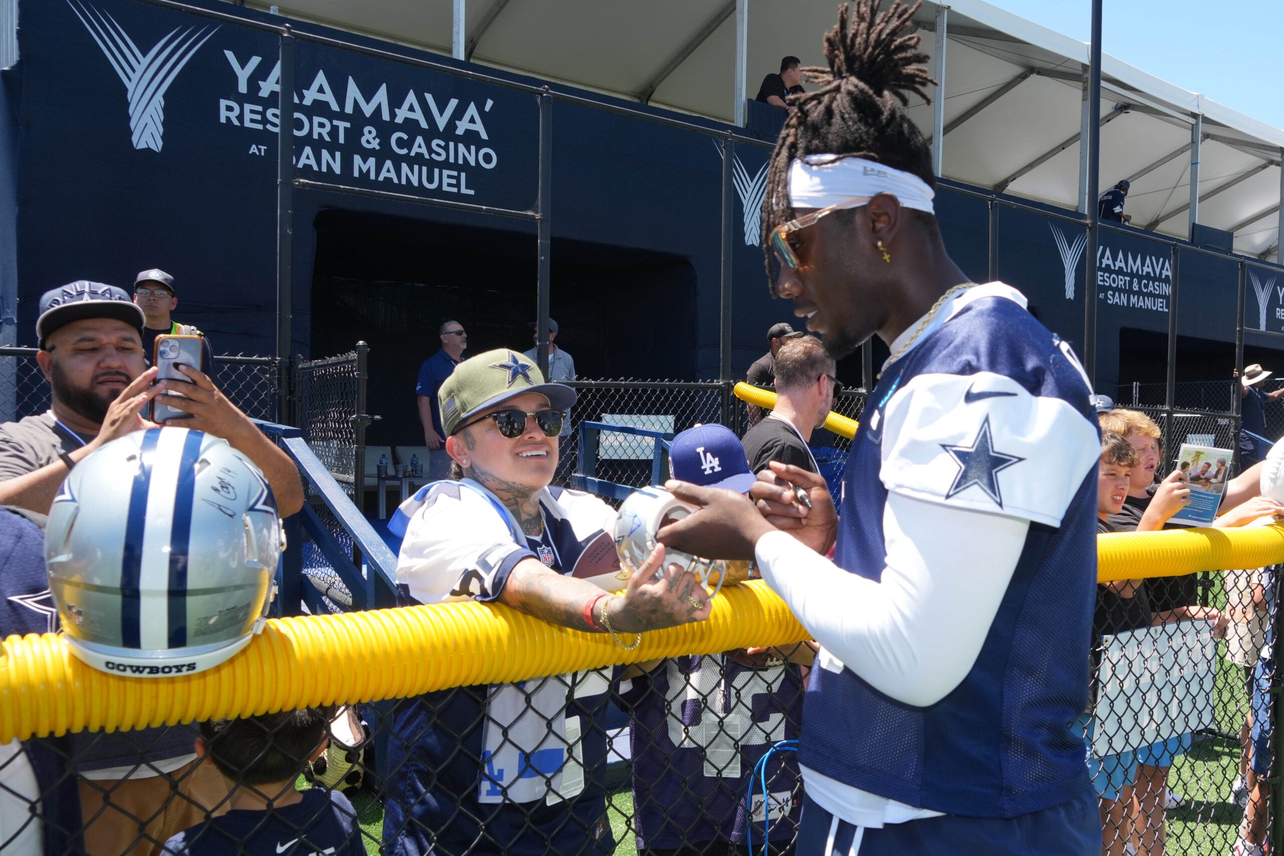 Jul 27, 2025; Oxnard, CA, USA; Dallas Cowboys linebacker DeMarvion Overshown (0) signs autographs at training camp at the River Ridge Fields.