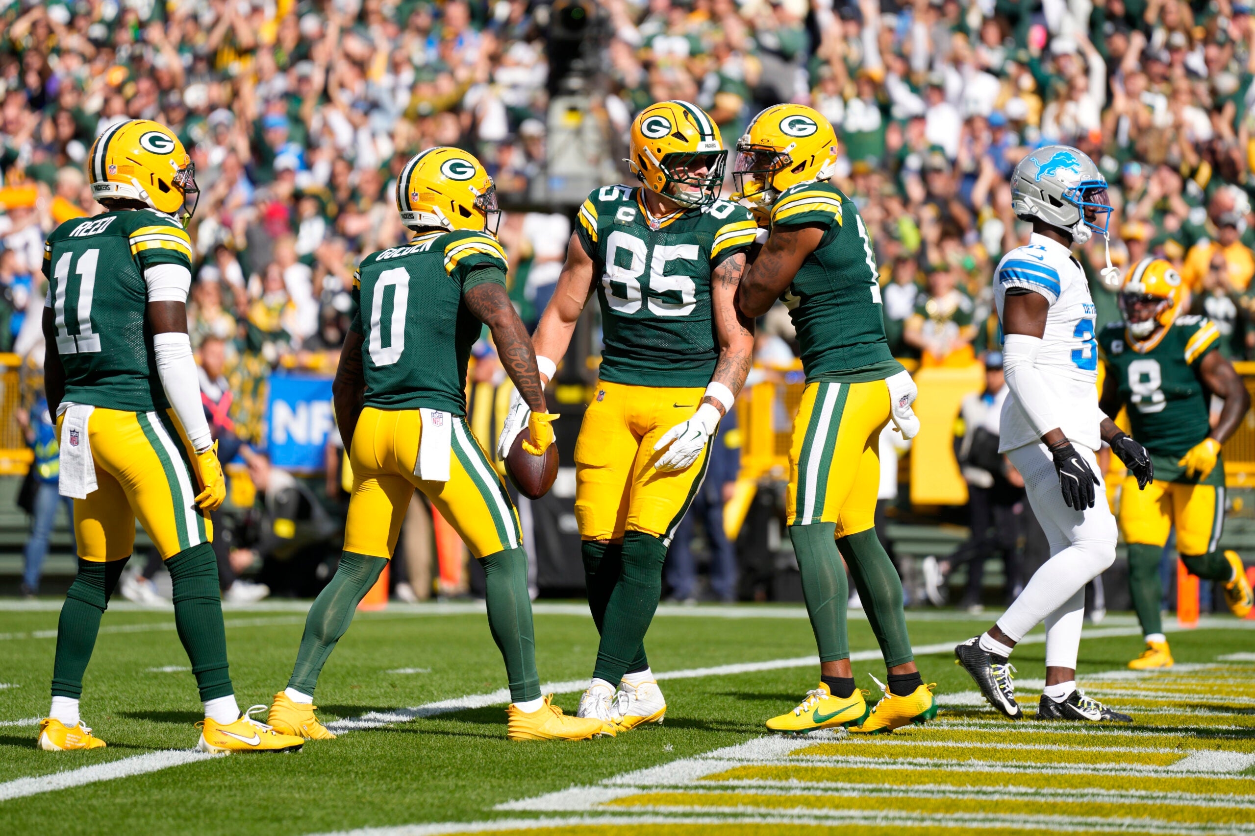Sep 7, 2025; Green Bay, Wisconsin, USA; Green Bay Packers tight end Tucker Kraft (85) celebrates with teammates after scoring a touchdown against the Detroit Lions during the first quarter at Lambeau Field.
