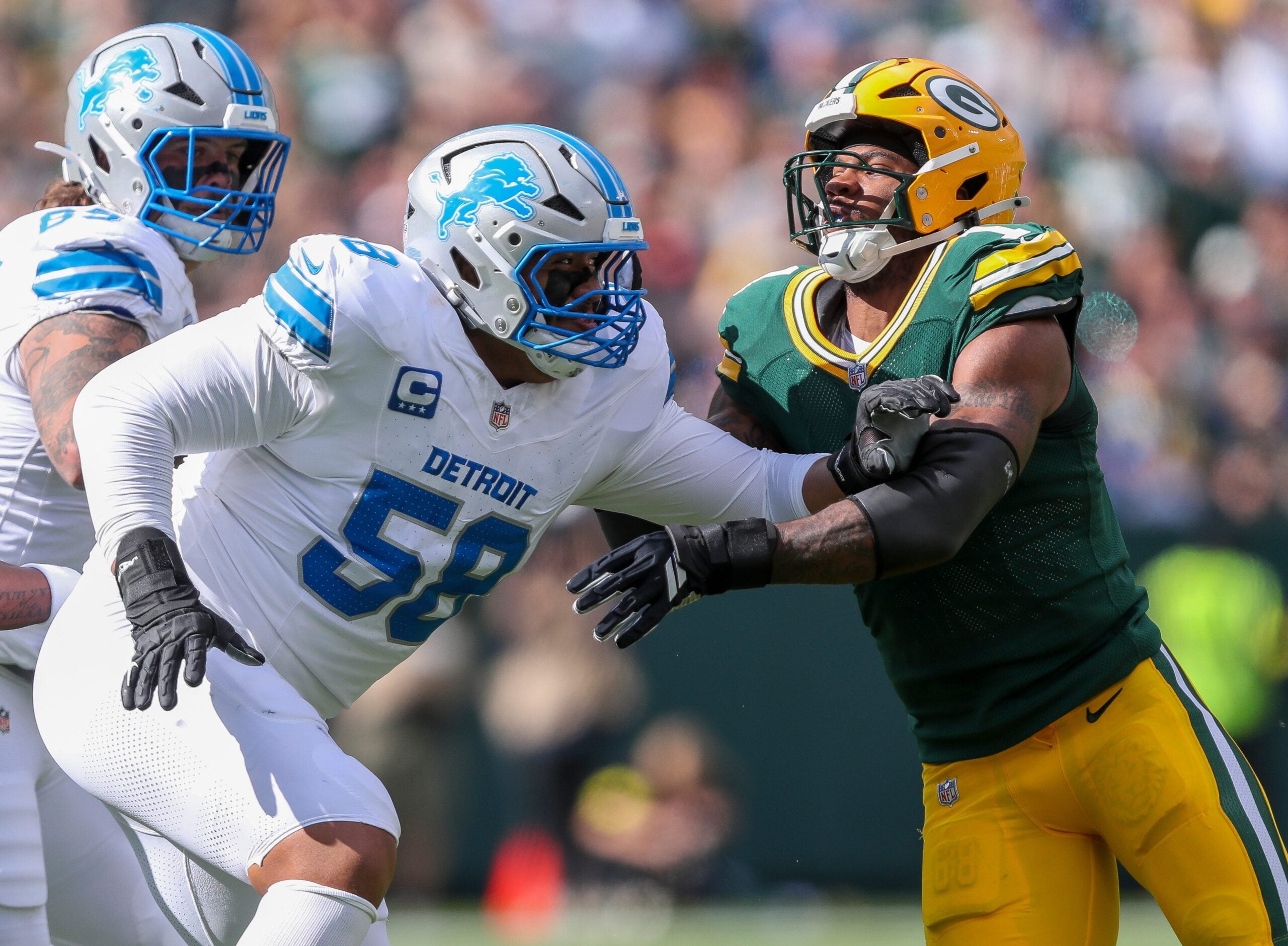Green Bay Packers defensive end Micah Parsons (1) fights through a block by Detroit Lions offensive tackle Penei Sewell (58) on Sunday, September 7, 2025, at Lambeau Field in Green Bay, Wis. The Packers won the game, 27-13.