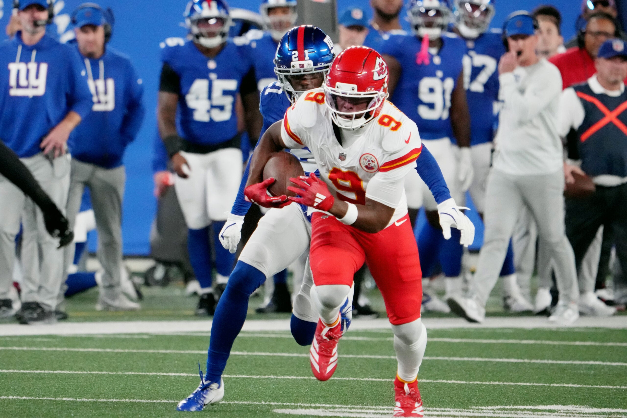 Sep 21, 2025; East Rutherford, New Jersey, USA; Kansas City Chiefs wide receiver Juju Smith-Schuster (9) runs against New York Giants cornerback Paulson Adebo (21) in the second quarter at MetLife Stadium.