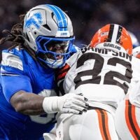Detroit Lions defensive tackle Tyleik Williams (91) tackles Cleveland Browns running back Dylan Sampson (22) during the first half at Ford Field in Detroit on Sunday, Sept. 28, 2025.