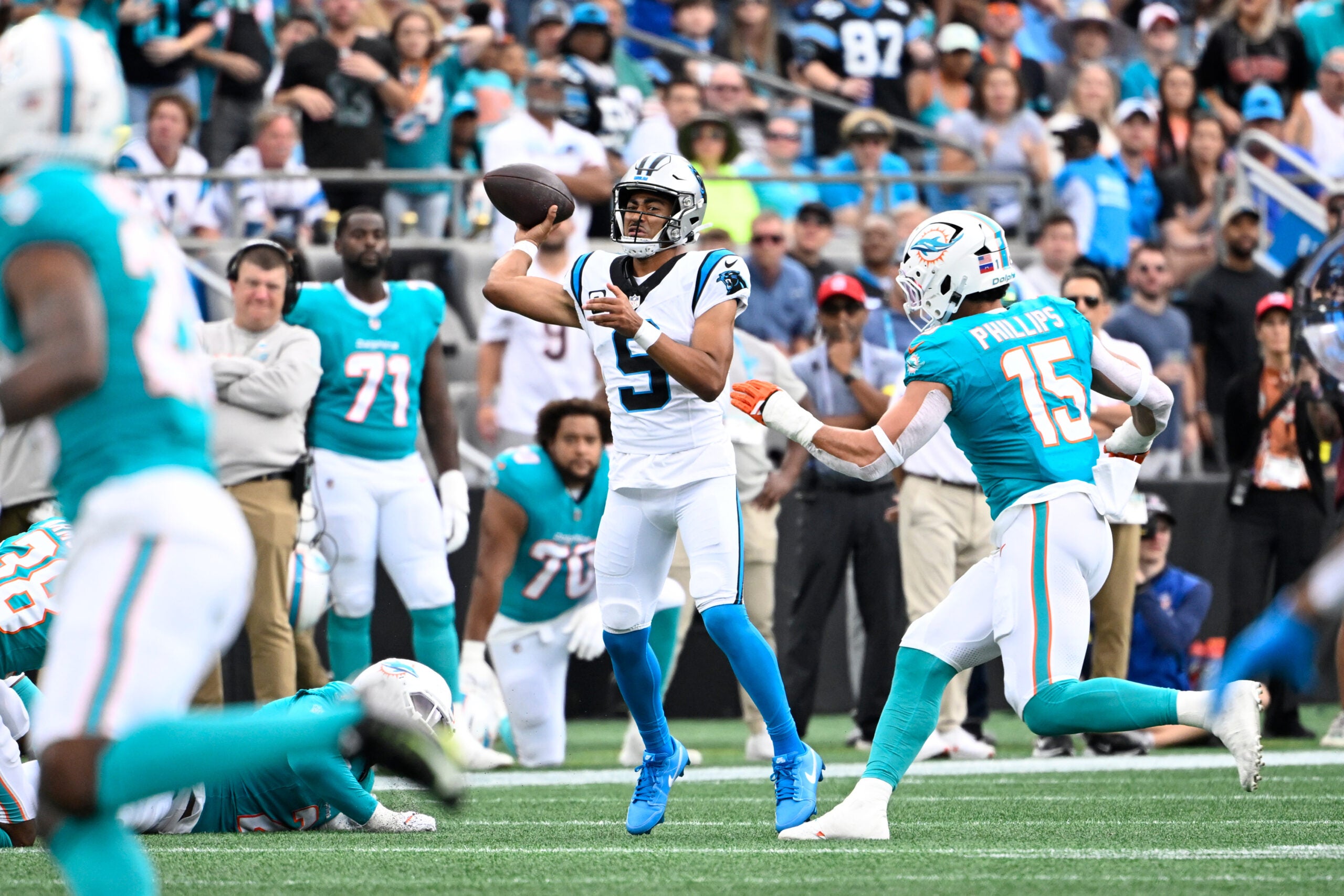Oct 5, 2025; Charlotte, North Carolina, USA; Carolina Panthers quarterback Bryce Young (9) passes the ball as Miami Dolphins linebacker Jaelan Phillips (15) pressures in the second quarter at Bank of America Stadium.