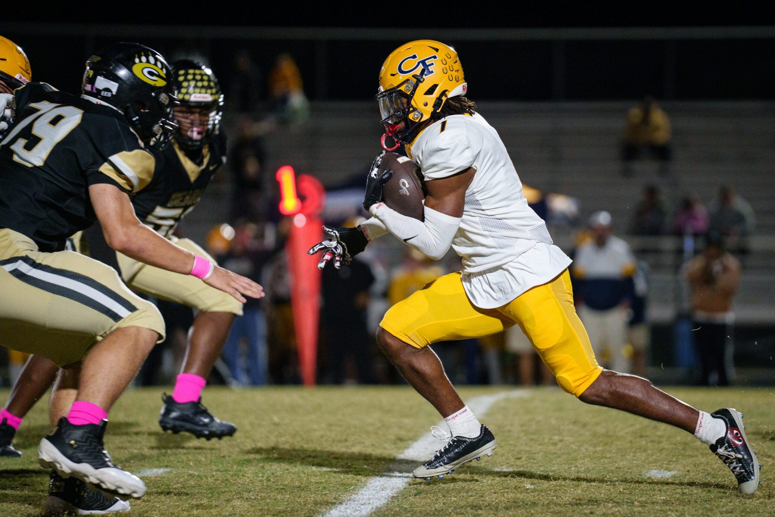 Tai Phillips carries the ball during the Cape Fear at Gray's Creek football game on Friday, Oct. 17, 2025.