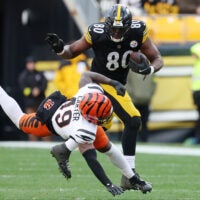 Nov 16, 2025; Pittsburgh, Pennsylvania, USA; Pittsburgh Steelers tight end Darnell Washington (80) runs with the ball against Cincinnati Bengals linebacker Barrett Carter (49) during the first half at Acrisure Stadium.