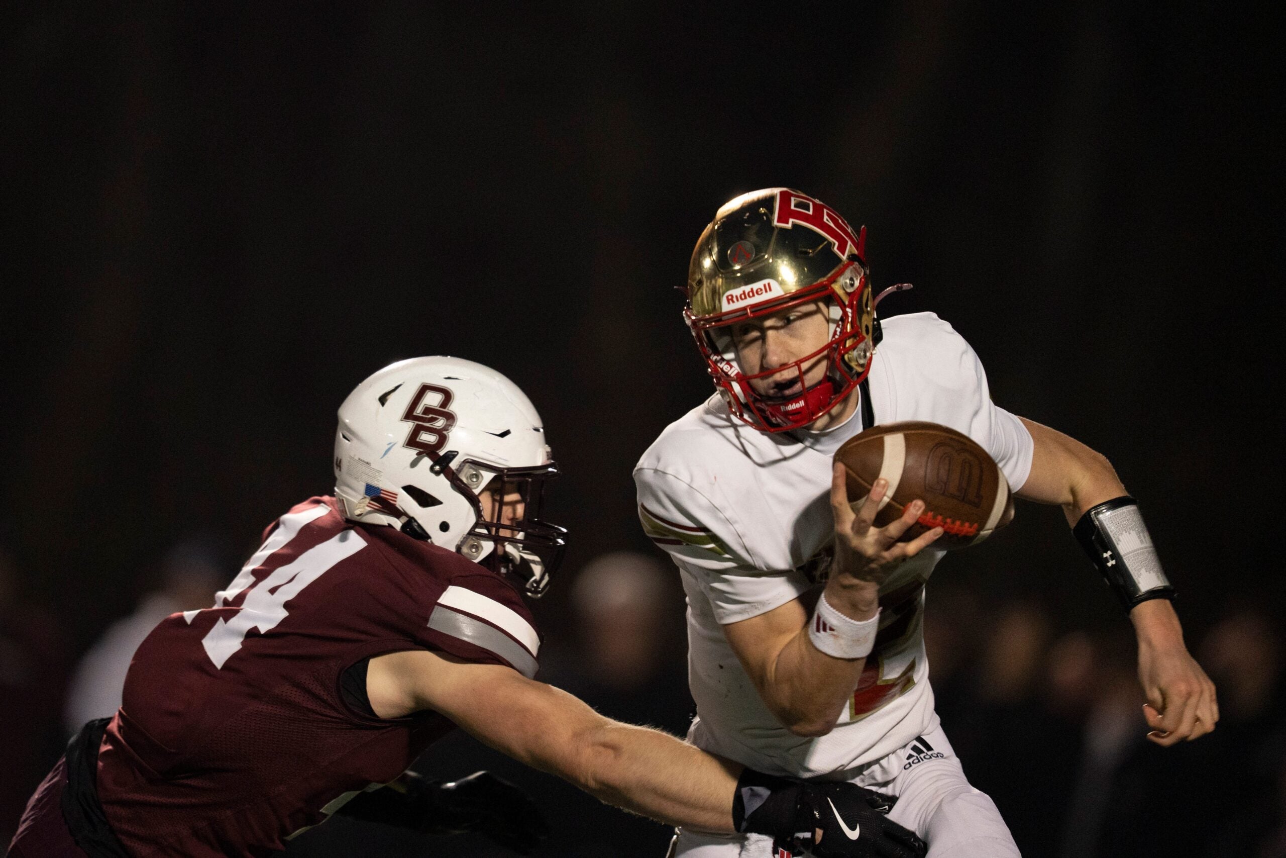 Bergen Catholic's Trey Tagliaferri (12) is sacked by Don Bosco's Jack Hinspeter (44) during Non-Public, Group A semifinal football game between Don Bosco and Bergen Catholic at Granatell Stadium in Ramsey on Friday, Nov. 21, 2025.