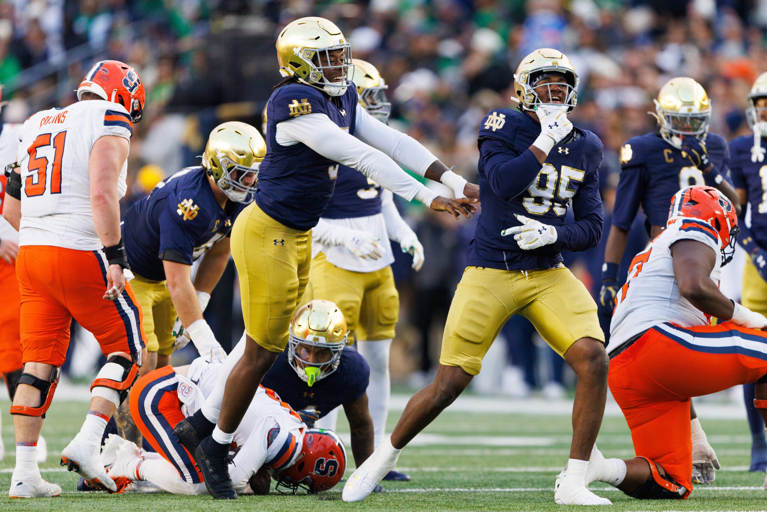 Notre Dame defensive lineman Bryce Young (95) celebrates sacking Syracuse quarterback Joseph Filardi, bottom left, in the first half of a NCAA football game against Syracuse at Notre Dame Stadium on Saturday, Nov. 22, 2025, in South Bend.