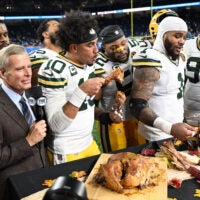 Nov 27, 2025; Detroit, Michigan, USA; Green Bay Packers quarterback Jordan Love (10), Green Bay Packers defensive end Micah Parsons (1) and Green Bay Packers defensive tackle Warren Brinson (91) eat turkey after defeating the Detroit Lions at Ford Field.