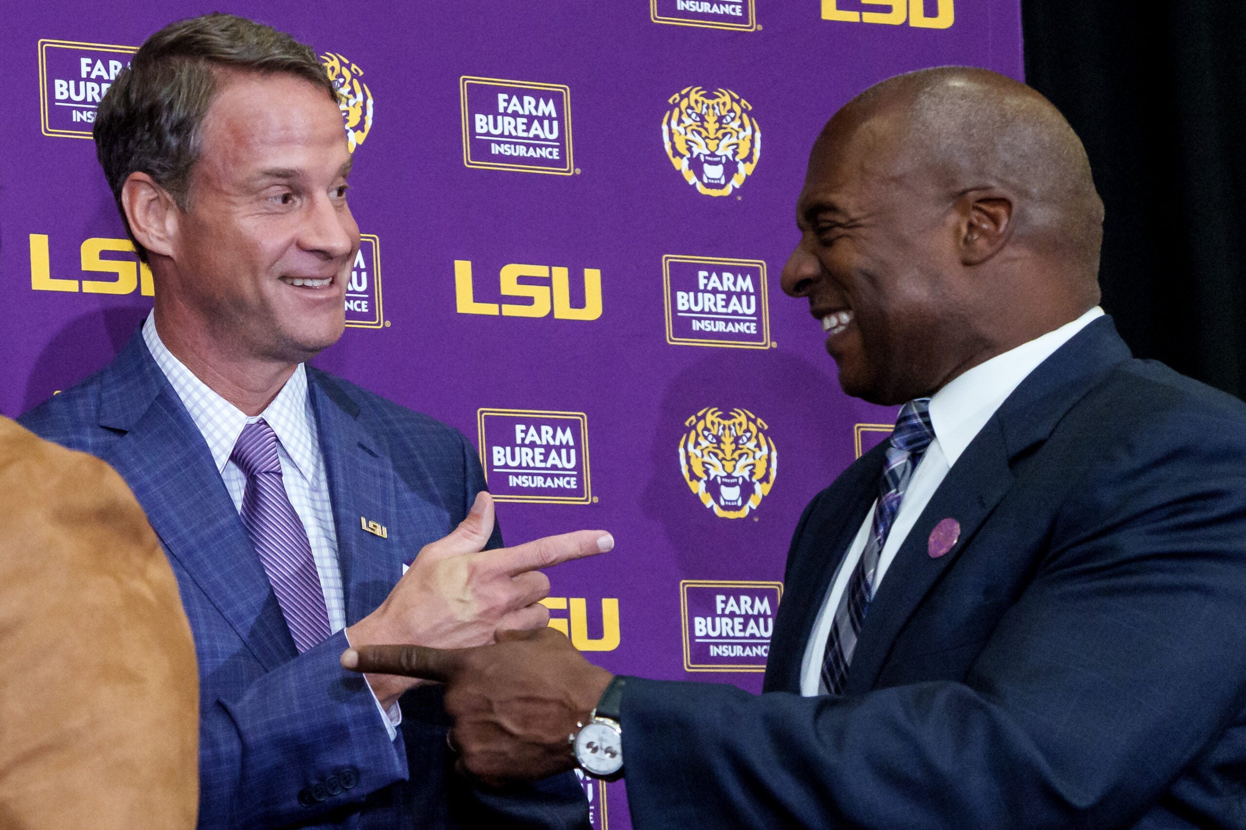 Dec 1, 2025; Baton Rouge, LA, USA; LSU new head coach Lane Kiffin, left, and LSU athletic director Verge Ausberry greet each other at South Stadium Club at Tiger Stadium.