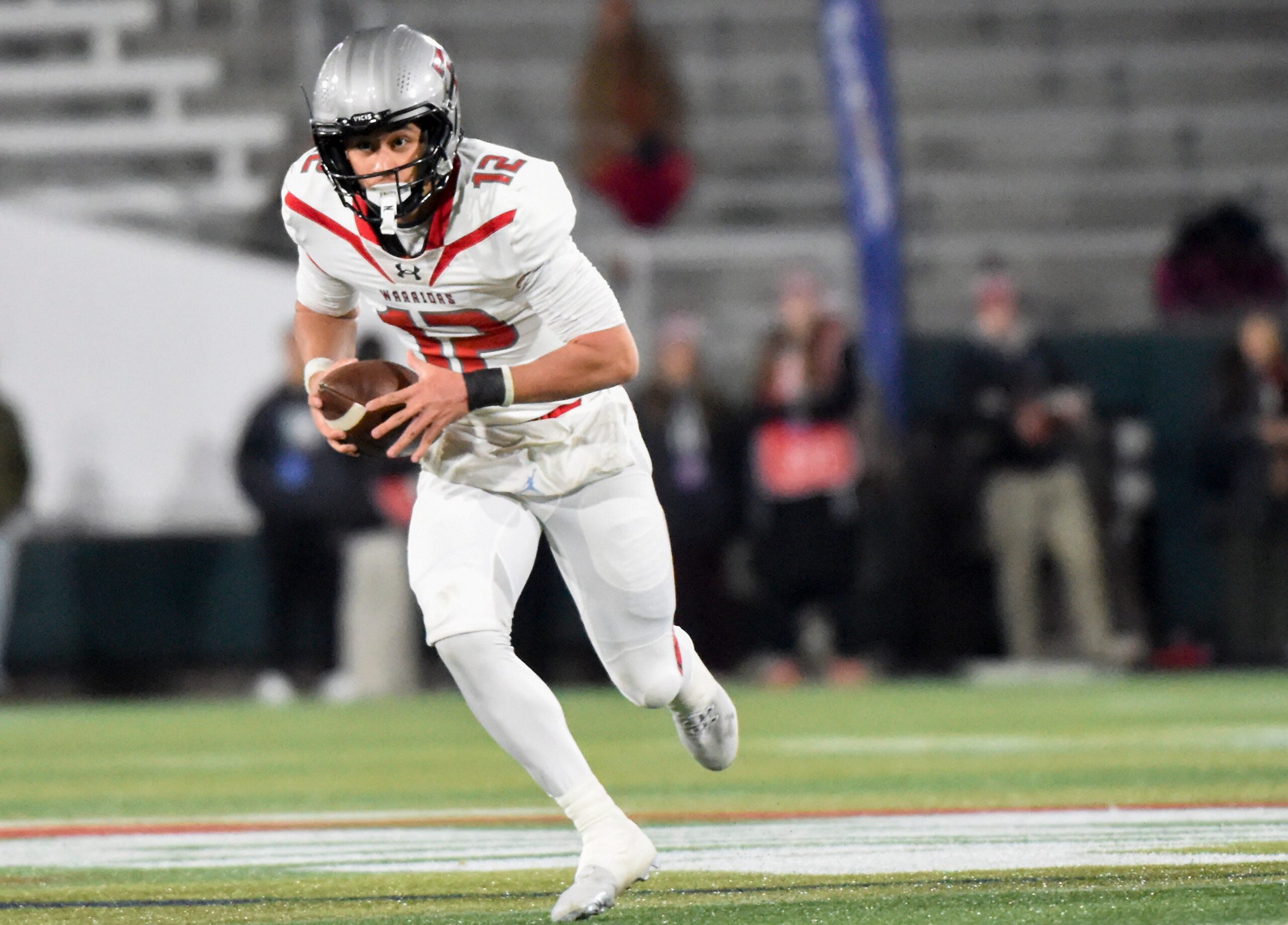 Thompson's quarterback Trent Seaborn (12) carries the ball against Opelika during their AHSAA 7A Football State Championship game in Birmingham, Ala. on Wednesday December 3, 2025.