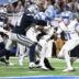 Dec 4, 2025; Detroit, Michigan, USA; Detroit Lions running back Jahmyr Gibbs (0) scores a touchdown against Dallas Cowboys safety Markquese Bell (14) and safety Donovan Wilson (6) during the second half at Ford Field.
