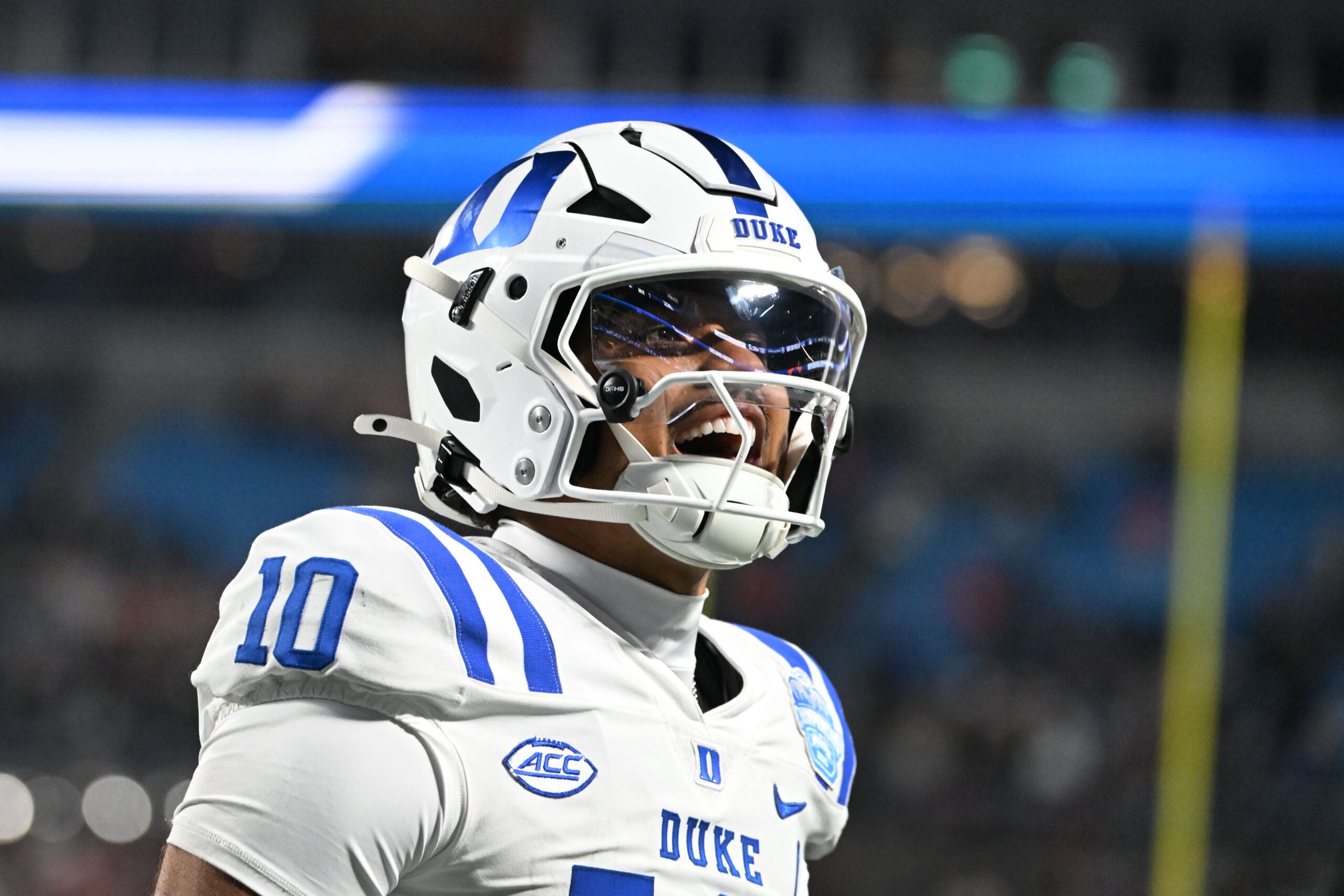Dec 6, 2025; Charlotte, NC, USA; Duke Blue Devils quarterback Darian Mensah (10) celebrates after the Blue Devils score a touchdown in overtime during the ACC Championship game at Bank of America Stadium.