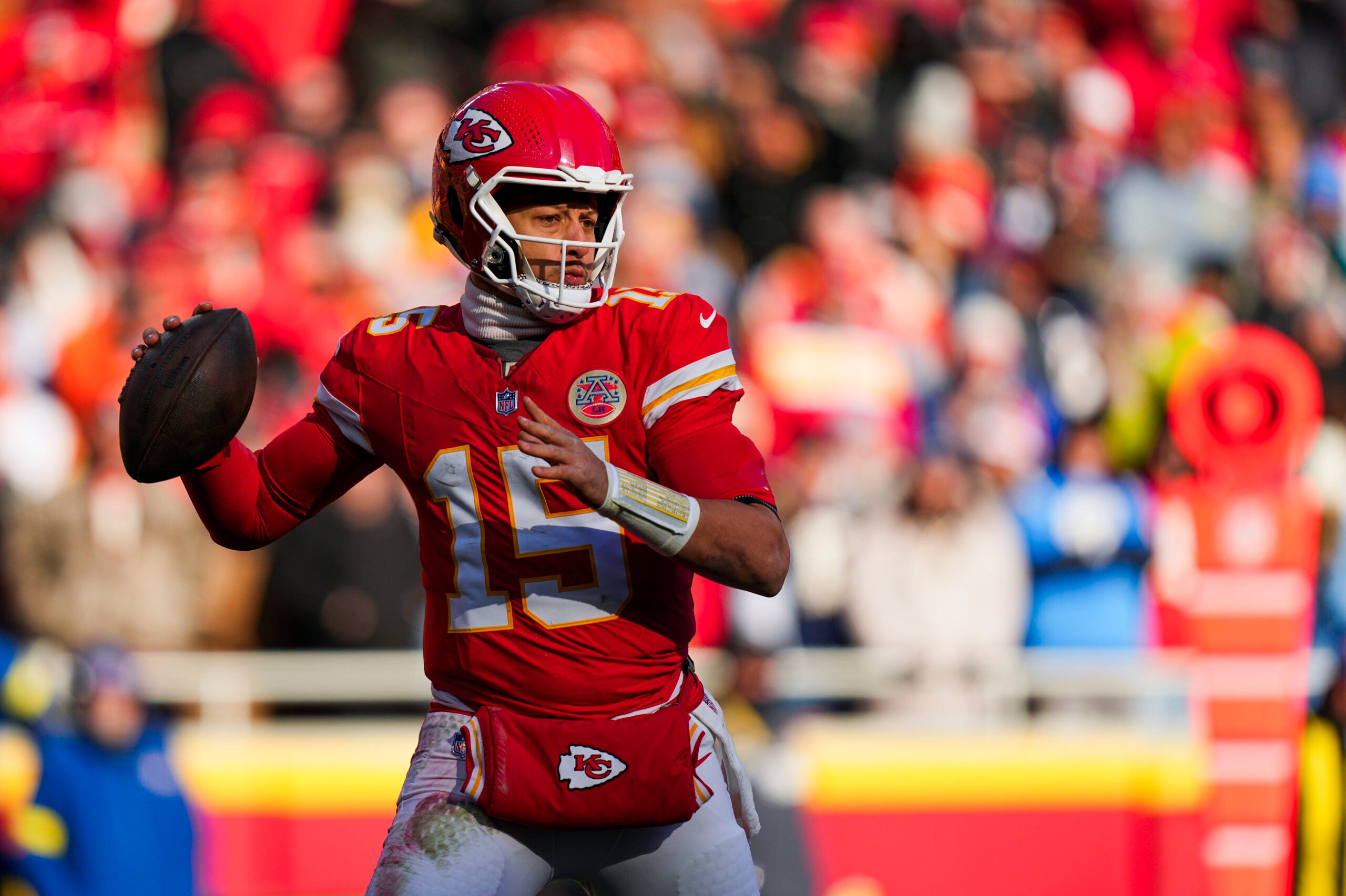 Dec 14, 2025; Kansas City, Missouri, USA; Kansas City Chiefs quarterback Patrick Mahomes (15) looks to pass against the Los Angeles Chargers during the second quarter at GEHA Field at Arrowhead Stadium.