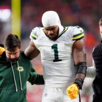 Dec 14, 2025; Denver, Colorado, USA; Green Bay Packers defensive end Micah Parsons (1) walks off the field with help from medical personnel following an injury during the third quarter against the Denver Broncos at Empower Field at Mile High.