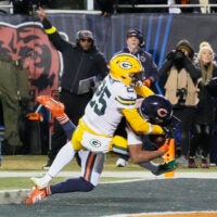 Dec 20, 2025; Chicago, Illinois, USA; Chicago Bears wide receiver DJ Moore (2) catches the game-winning forty-six yard touchdown pass thrown by quarterback Caleb Williams (not pictured) against Green Bay Packers cornerback Keisean Nixon (25) in overtime at Soldier Field.