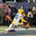 Dec 20, 2025; Chicago, Illinois, USA; Chicago Bears wide receiver DJ Moore (2) catches the game-winning forty-six yard touchdown pass thrown by quarterback Caleb Williams (not pictured) against Green Bay Packers cornerback Keisean Nixon (25) in overtime at Soldier Field.
