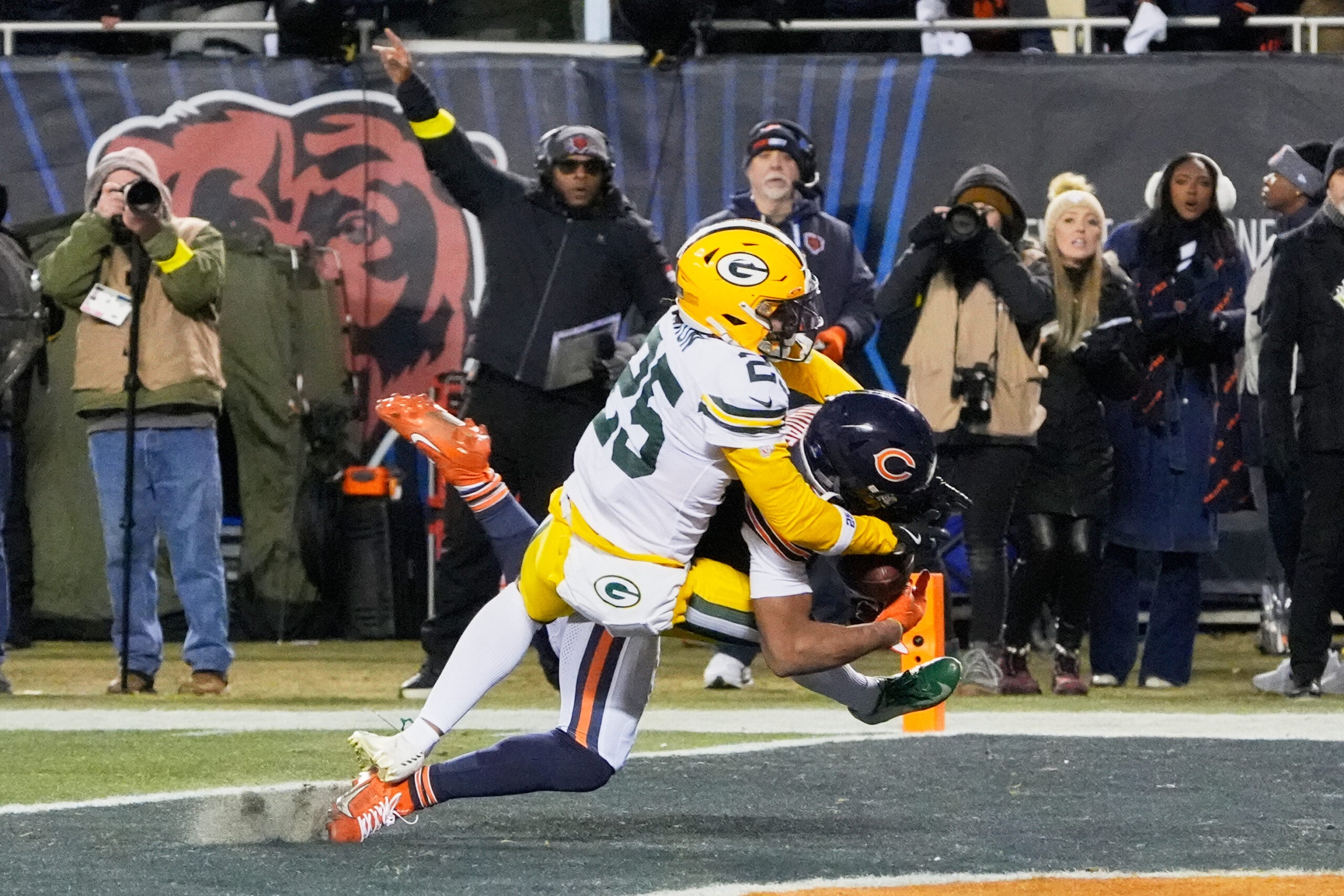 Dec 20, 2025; Chicago, Illinois, USA; Chicago Bears wide receiver DJ Moore (2) catches the game-winning forty-six yard touchdown pass thrown by quarterback Caleb Williams (not pictured) against Green Bay Packers cornerback Keisean Nixon (25) in overtime at Soldier Field.