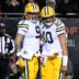 Jan 10, 2026; Chicago, IL, USA; Green Bay Packers wide receiver Christian Watson (9) and quarterback Jordan Love (10) react after hooking up on a touchdown pass and catch against the Chicago Bears during the first half of an NFC Wild Card Round game at Soldier Field.