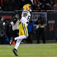Jan 10, 2026; Chicago, IL, USA; in Green Bay Packers linebacker Edgerrin Cooper (56) reacts after he takes down Chicago Bears running back Kyle Monangai (25) during an NFC Wild Card Round game at Soldier Field.