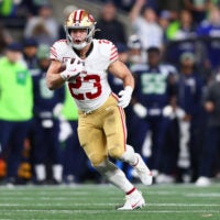 Jan 17, 2026; Seattle, WA, USA; San Francisco 49ers running back Christian McCaffrey (23) runs after the catch against the Seattle Seahawks during the first half in an NFC Divisional Round game at Lumen Field.