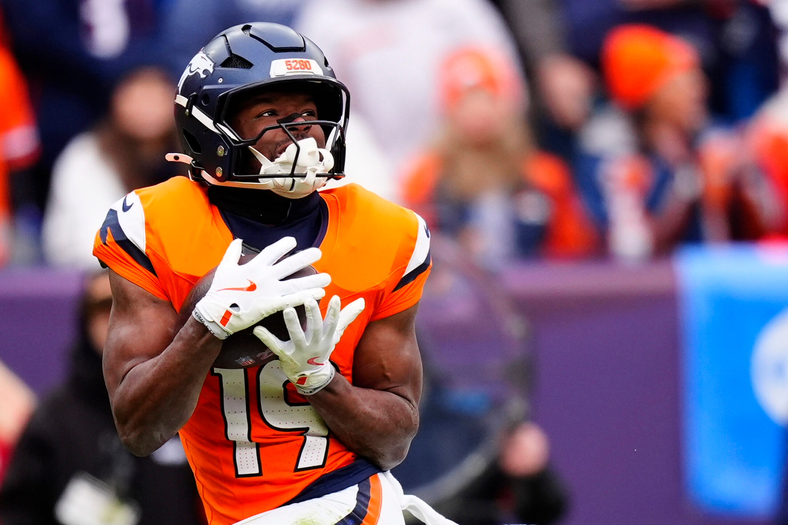 Jan 25, 2026; Denver, CO, USA; Denver Broncos wide receiver Marvin Mims Jr. (19) makes a catch against the New England Patriots during the first half in the 2026 AFC Championship Game at Empower Field at Mile High.