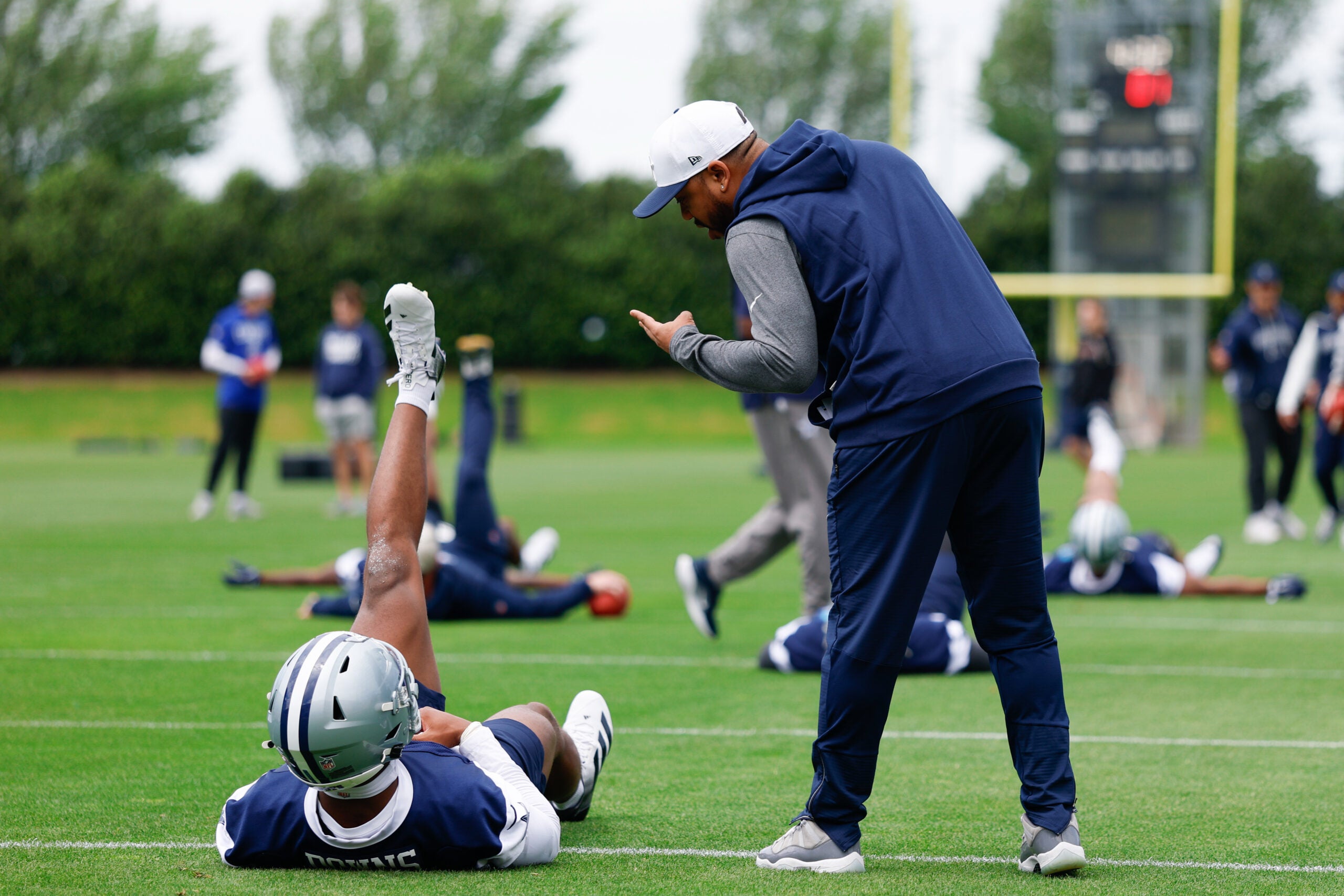 May 1, 2026; Frisco, TX, USA; Dallas Cowboys cornerback Caleb Downs (18) speaks with defensive coordinator Christian Parker during practice at the Ford Center at the Star Training Facility in Frisco, Texas.