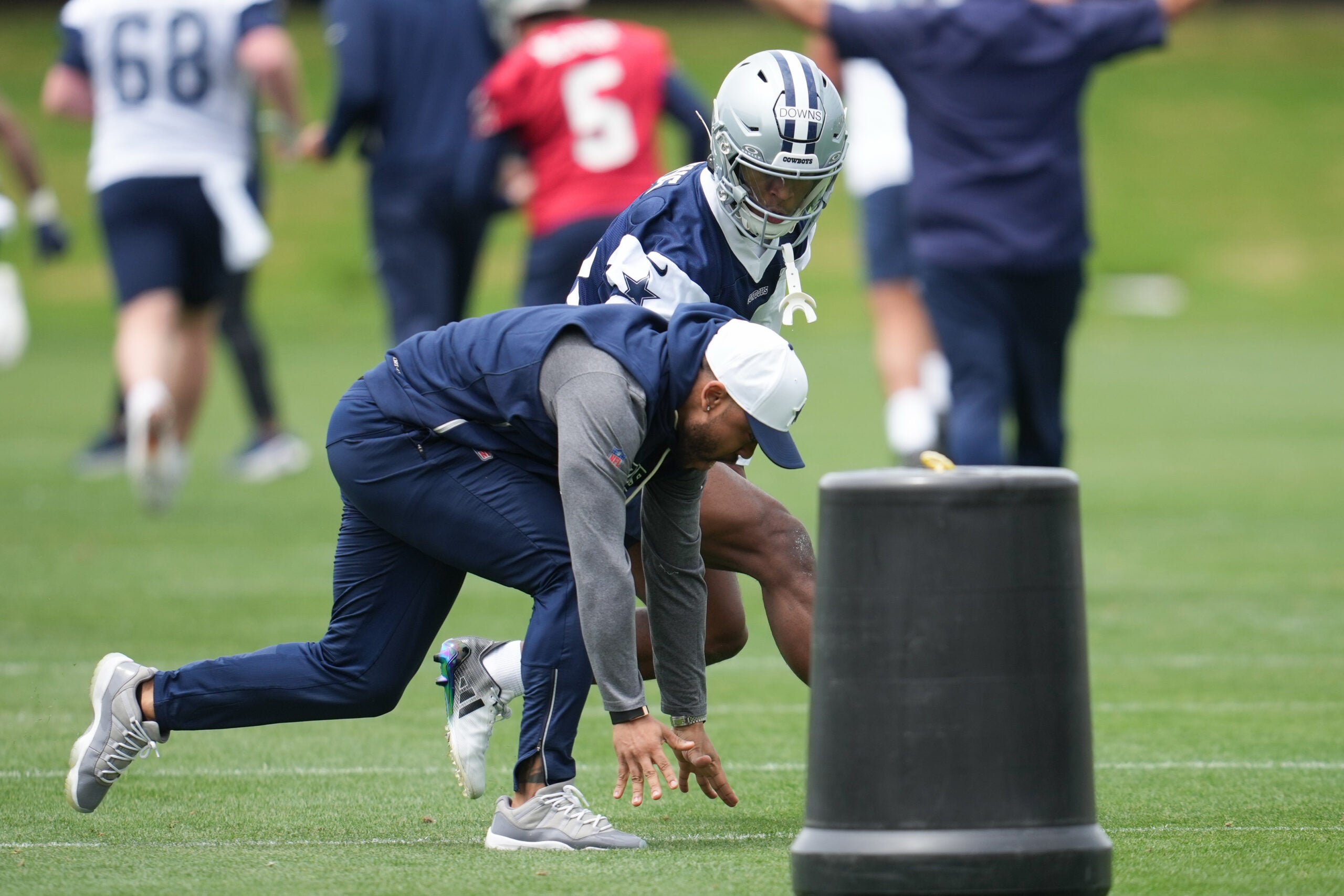 May 1, 2026; Frisco, TX, USA; Dallas Cowboys cornerback Caleb Downs (18) is coached through a drill with defensive coordinator Christian Parker at the Ford Center at the Star Training Facility in Frisco, Texas.