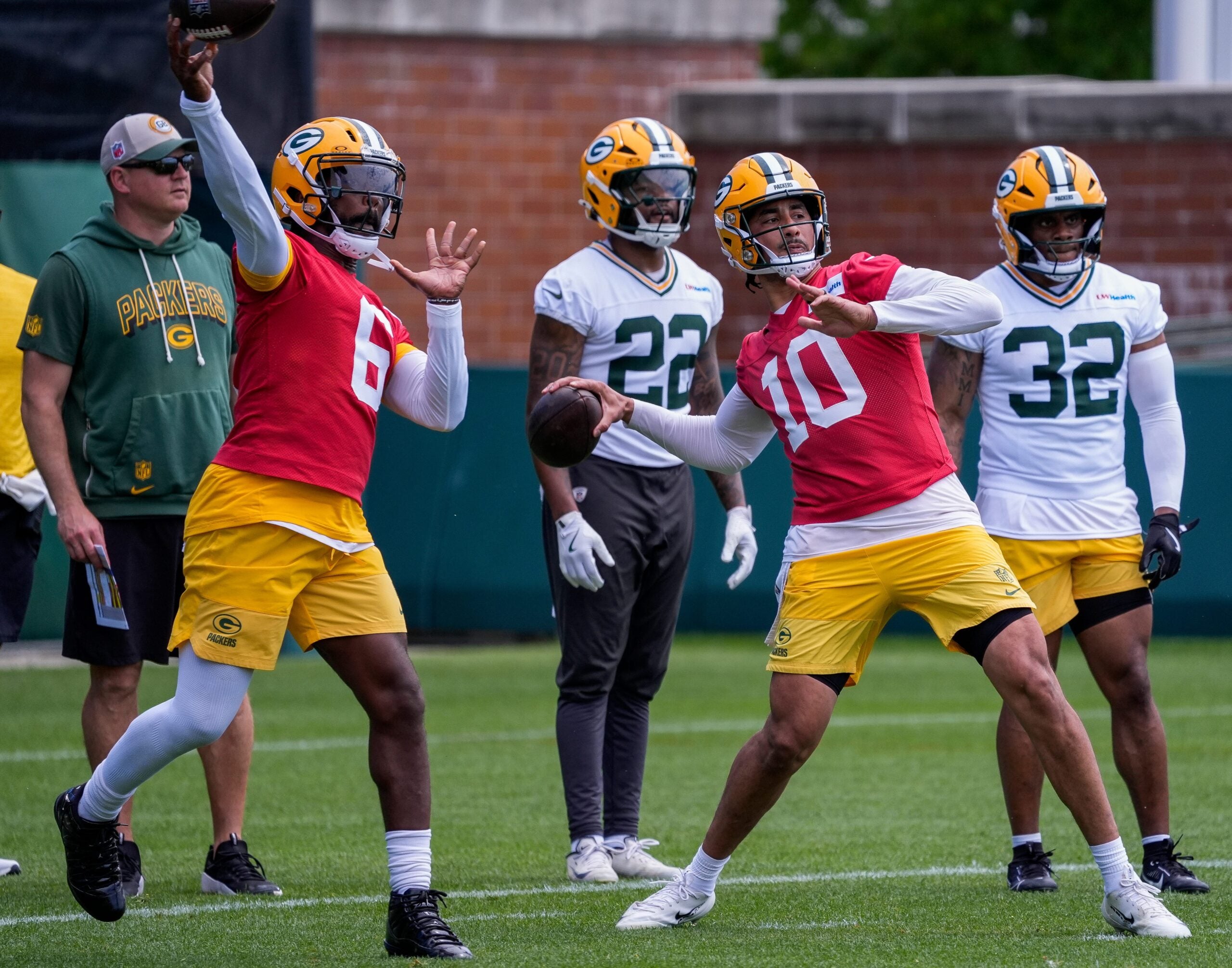 Green Bay Packers quarterbacks Tyrod Taylor (6) and Jordan Love (10) throw passes during practice on Wednesday, May 26, 2026, at Ray Nitschke Field in Ashwaubenon, Wis.