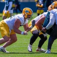 Green Bay Packers offensive lineman Jager Burton (52) runs through a drill during practice on Tuesday, June 2, 2026, at Ray Nitschke Field in Ashwaubenon, Wis.