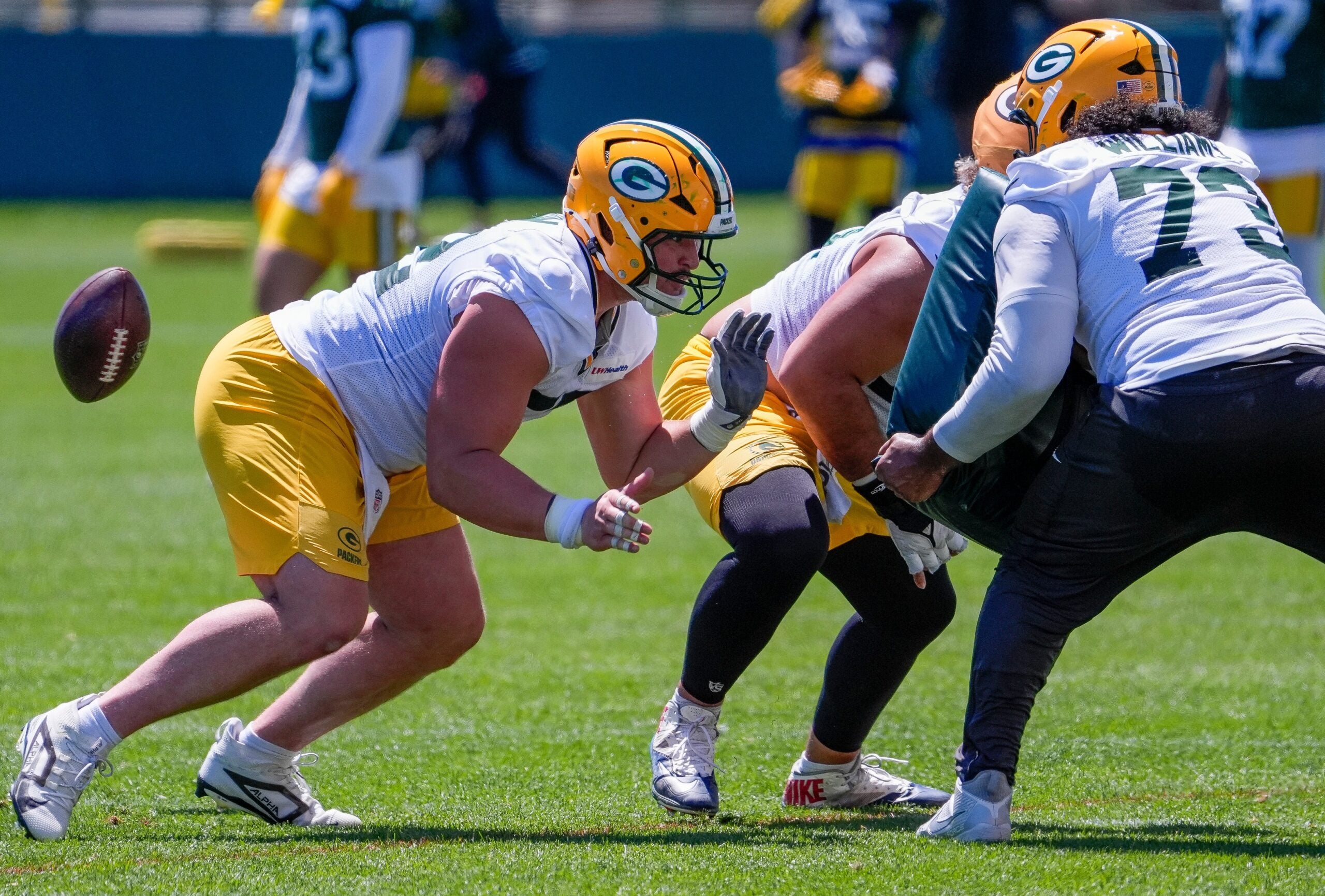 Green Bay Packers offensive lineman Jager Burton (52) runs through a drill during practice on Tuesday, June 2, 2026, at Ray Nitschke Field in Ashwaubenon, Wis.