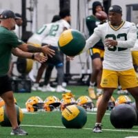 Green Bay Packers running back MarShawn Lloyd (32) tosses a medicine ball during practice on Tuesday, June 2, 2026, at the Don Hutson Center in Ashwaubenon, Wis.