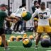 Green Bay Packers running back MarShawn Lloyd (32) tosses a medicine ball during practice on Tuesday, June 2, 2026, at the Don Hutson Center in Ashwaubenon, Wis.