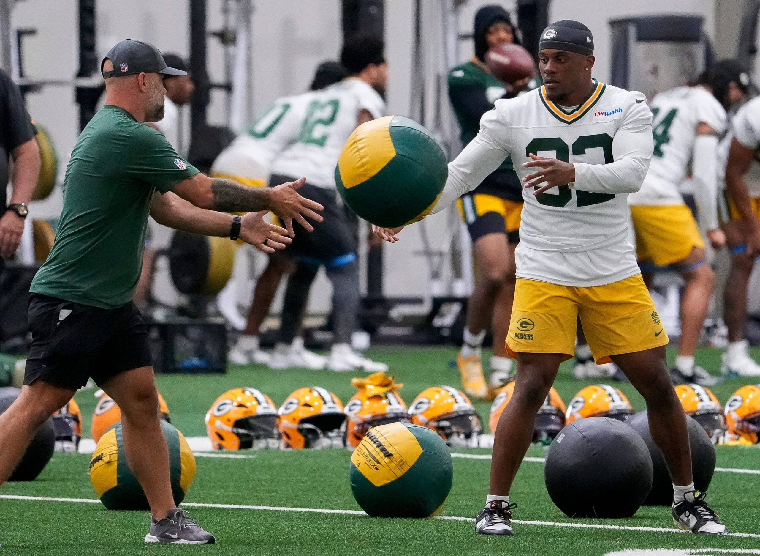 Green Bay Packers running back MarShawn Lloyd (32) tosses a medicine ball during practice on Tuesday, June 2, 2026, at the Don Hutson Center in Ashwaubenon, Wis.
