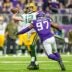 Nov 21, 2021; Minneapolis, Minnesota, USA; Green Bay Packers quarterback Aaron Rodgers (12) throws a touchdown pass in front of Minnesota Vikings defensive end Everson Griffen (97) during the fourth quarter at U.S. Bank Stadium.