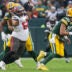 Dec 17, 2023; Green Bay, Wisconsin, USA; Tampa Bay Buccaneers defensive tackle Vita Vea (50) is held by Green Bay Packers center Josh Myers (71) as he rushes quarterback Jordan Love (10) at Lambeau Field.