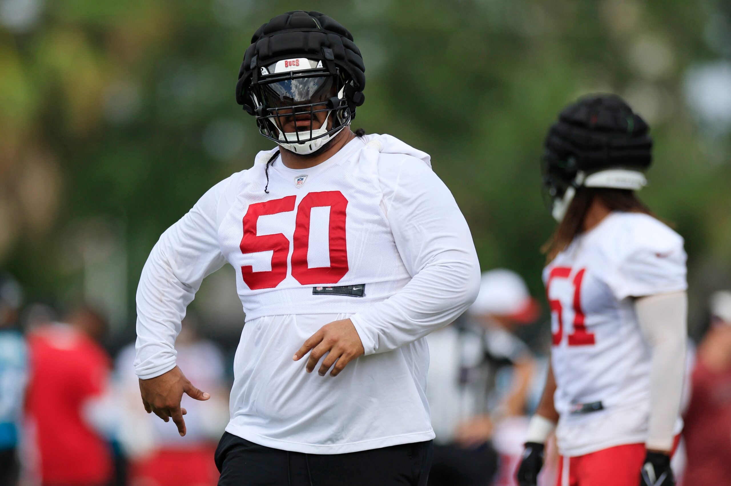 Tampa Bay Buccaneers defensive tackle Vita Vea (50) walks on the field during a combined NFL football training camp session between the Tampa Bay Buccaneers and Jacksonville Jaguars Thursday, Aug. 15, 2024 at EverBank Stadium’s Miller Electric Center in Jacksonville, Fla.