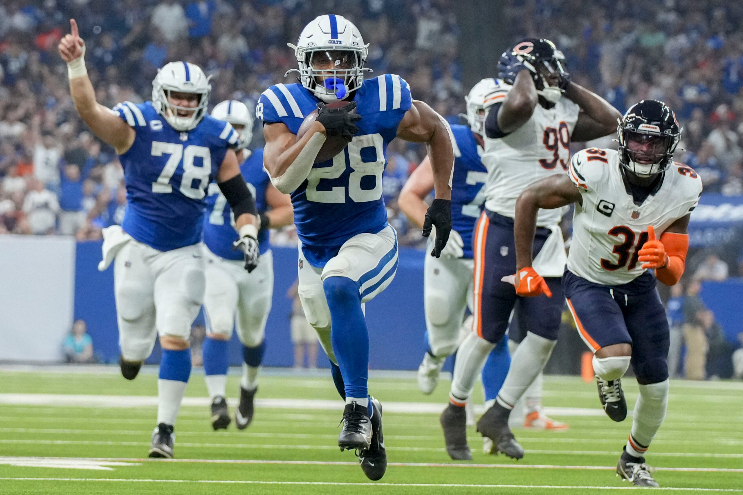 Sep 22, 2024; Indianapolis, Indiana, USA; Indianapolis Colts running back Jonathan Taylor (28) rushes for a touchdown during a game against the Chicago Bears at Lucas Oil Stadium.