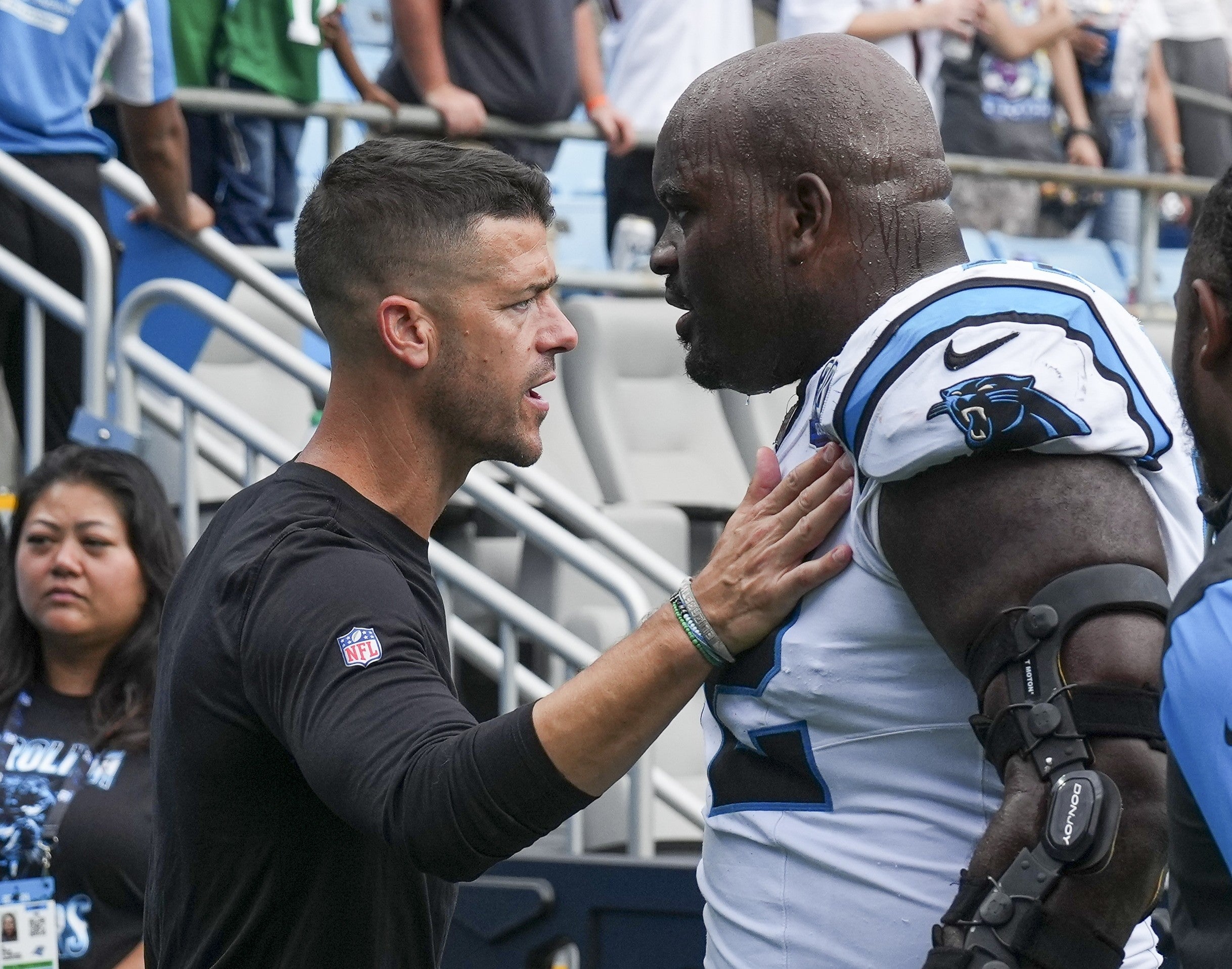 Sep 29, 2024; Charlotte, North Carolina, USA; Carolina Panthers head coach Dave Canales greets offensive tackle Taylor Moton (72) as he leaves the field after the fourth quarter against the Cincinnati Bengals at Bank of America Stadium.