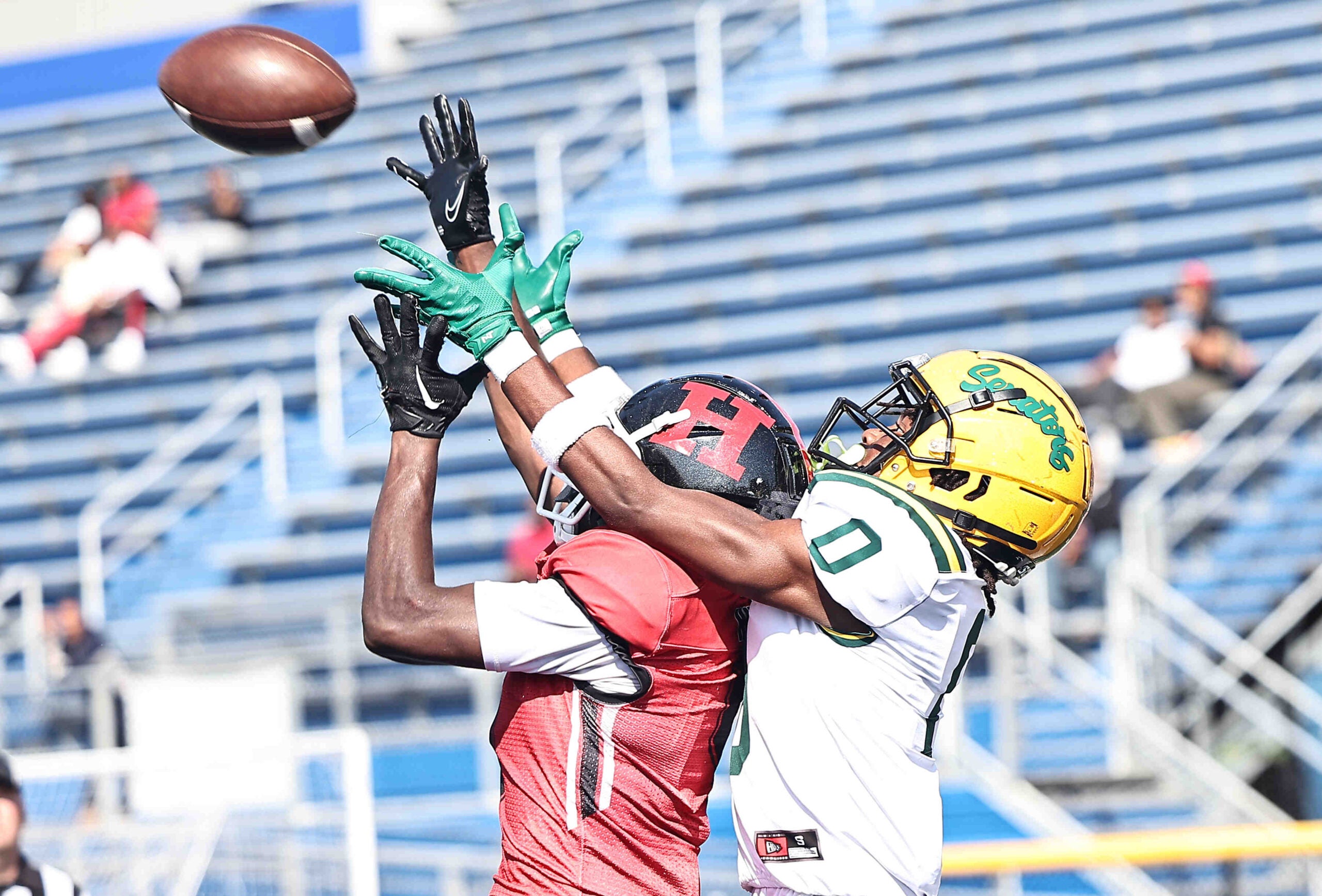 Hughes defensive back Michael Morton (4) intercepts a pass intended for Taft receiver Lorenzo McMullen (0) during the Senators' win over Hughes Saturday, Oct. 5, 2024.