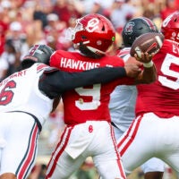 Oct 19, 2024; Norman, Oklahoma, USA; South Carolina Gamecocks edge Dylan Stewart (6) hits Oklahoma Sooners quarterback Michael Hawkins Jr. (9) and causes an interception during the first half at Gaylord Family-Oklahoma Memorial Stadium.
