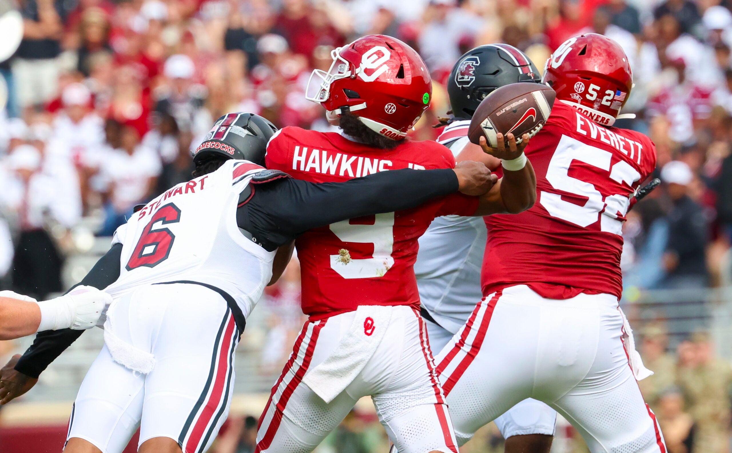 Oct 19, 2024; Norman, Oklahoma, USA; South Carolina Gamecocks edge Dylan Stewart (6) hits Oklahoma Sooners quarterback Michael Hawkins Jr. (9) and causes an interception during the first half at Gaylord Family-Oklahoma Memorial Stadium.