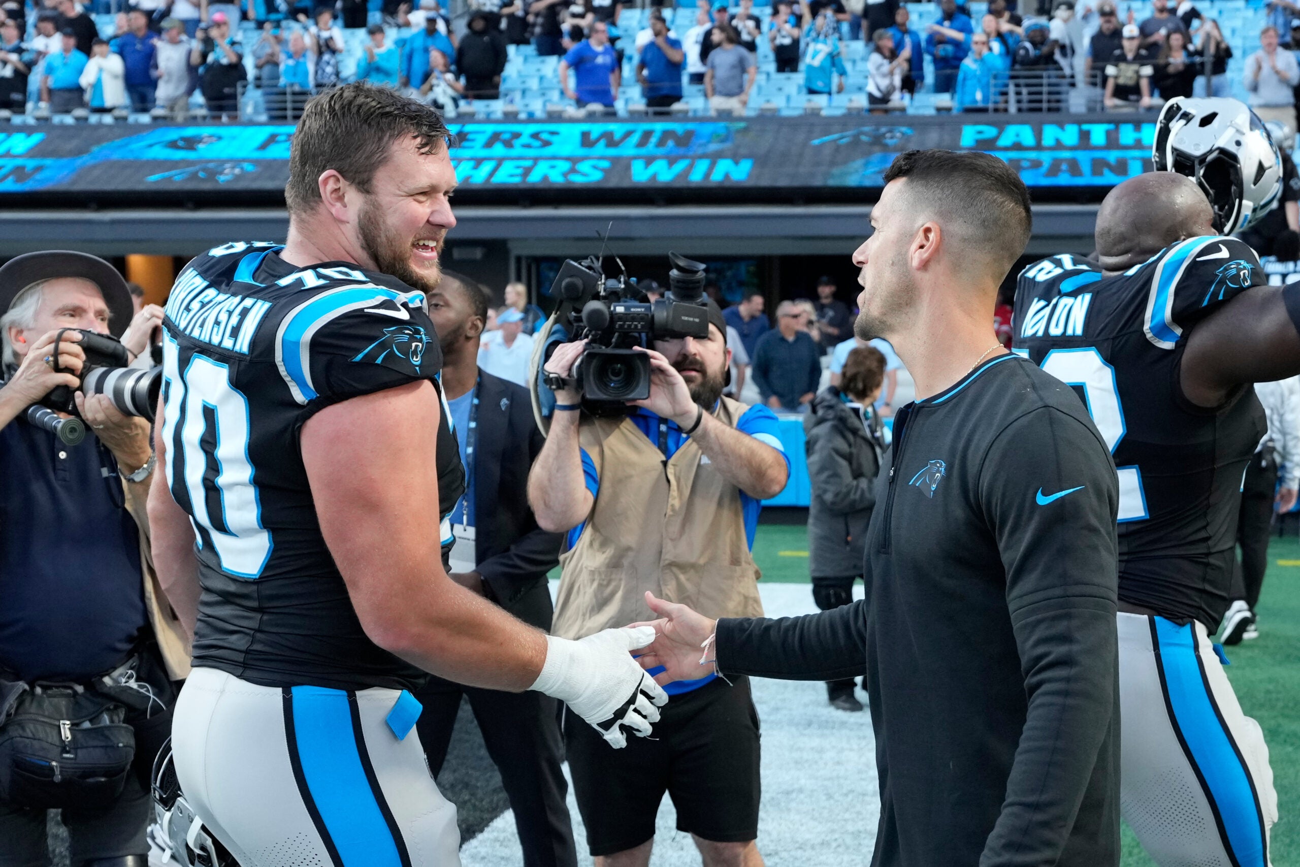 Nov 3, 2024; Charlotte, North Carolina, USA; Carolina Panthers guard Brady Christensen (70) with head coach Dave Canales after the game at Bank of America Stadium.