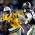 Nov 23, 2024; Baton Rouge, Louisiana, USA; LSU Tigers cornerback Zy Alexander (14) tackles Vanderbilt Commodores quarterback Nate Johnson (8) during the second half at Tiger Stadium.