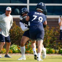 Jul 23, 2025; Lake Forest, IL, USA; Chicago Bears guard Theo Benedet (79) and offensive tackle Darnell Wright (58) run a drill during training camp at Halas Hall.