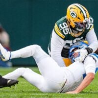 Detroit Lions quarterback Jared Goff is tackled by Green Bay Packers defensive tackle Devonte Wyatt during the second half at Lambeau Field in Green Bay, Wis., on Sunday, September 7, 2025.