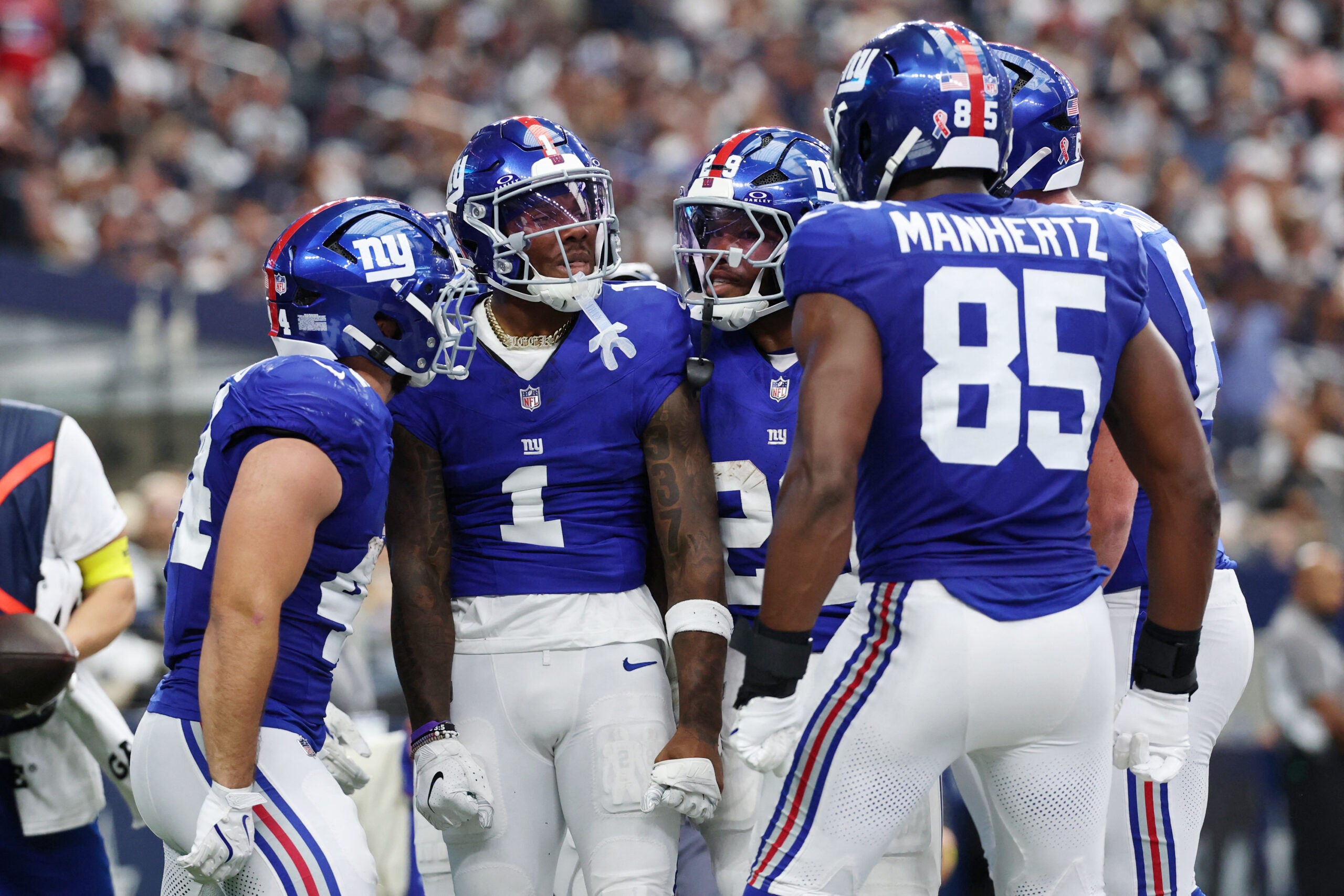 Sep 14, 2025; Arlington, Texas, USA; New York Giants wide receiver Malik Nabers (1) celebrates with teammates after scoring a touchdown against the Dallas Cowboys during the second quarter at AT&T Stadium.